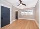 Bedroom with hardwood floors, a ceiling fan and two closets for ample storage at 1505 Delaney Ave, Orlando, FL 32806