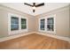 Comfortable bedroom with a ceiling fan, hardwood floors and bright natural light at 1505 Delaney Ave, Orlando, FL 32806