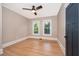 Bedroom with beautiful hardwood floors, a ceiling fan and bright windows at 1505 Delaney Ave, Orlando, FL 32806