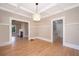 Elegant dining room with hardwood floors and detailed trim, seamlessly connecting to the living spaces for easy entertaining at 1505 Delaney Ave, Orlando, FL 32806