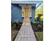Charming home featuring a tidy yard and inviting front door with sidelights and tile walkway at 1505 Delaney Ave, Orlando, FL 32806