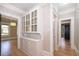 Hallway with storage cabinet connecting to rooms and hardwood flooring at 1505 Delaney Ave, Orlando, FL 32806