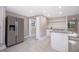 Kitchen featuring stainless steel appliances, white custom cabinets and white tile floors at 1505 Delaney Ave, Orlando, FL 32806