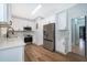 Well-lit kitchen showcasing white cabinets, stainless steel appliances, quartz countertops, and stylish backsplash, blending design and function at 1505 Delaney Ave, Orlando, FL 32806