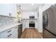 Bright kitchen featuring white cabinets, stainless steel appliances, mosaic backsplash, and hardwood floors for a modern look at 1505 Delaney Ave, Orlando, FL 32806