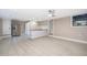 Open kitchen featuring stainless steel refrigerator, custom cabinets and light tile floors at 1505 Delaney Ave, Orlando, FL 32806
