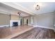 Spacious living room with hardwood floors, coffered ceilings, and modern lighting at 1505 Delaney Ave, Orlando, FL 32806