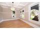 Bright living room featuring hardwood floors, large windows and decorative ceiling at 1505 Delaney Ave, Orlando, FL 32806