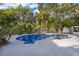 Inviting backyard pool surrounded by lush greenery and a spacious patio area, perfect for outdoor relaxation and entertainment at 1505 Delaney Ave, Orlando, FL 32806