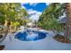 Beautiful kidney shaped pool surrounded by tropical landscaping at 1505 Delaney Ave, Orlando, FL 32806