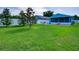 Beautiful backyard features a privacy fence, lush green grass and a patio area at 1618 Oregon Ave, St Cloud, FL 34769