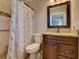Bathroom featuring a tiled shower with glass door, vanity with granite countertop, and tiled floor at 1618 Oregon Ave, St Cloud, FL 34769