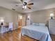 Bright bedroom with a ceiling fan, laminate flooring, and ample natural light at 1618 Oregon Ave, St Cloud, FL 34769