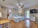 Bright bedroom with laminate flooring, ceiling fan, and a sliding glass door to the exterior at 1618 Oregon Ave, St Cloud, FL 34769
