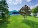 Home exterior with a pristine backyard featuring trees and green grass at 1618 Oregon Ave, St Cloud, FL 34769