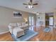 Spacious living room with hardwood floors, comfortable seating, and access to the dining and kitchen areas at 1618 Oregon Ave, St Cloud, FL 34769