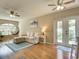 Comfortable living room with hardwood floors, ample natural light, a couch, and a hanging egg chair at 1618 Oregon Ave, St Cloud, FL 34769