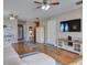 Bright living room offers wood floors, recessed lighting, TV, modern furniture, and an open design at 1618 Oregon Ave, St Cloud, FL 34769