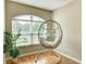 Cozy sitting area with natural light, a comfortable hanging chair, and stylish decor at 1618 Oregon Ave, St Cloud, FL 34769