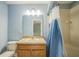 Cozy bathroom featuring a single vanity, tub-shower combo, and soft blue walls at 16449 Cedar Crest Dr, Orlando, FL 32828