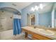 Well-lit bathroom featuring a tub-shower combo, single vanity, and tiled flooring at 16449 Cedar Crest Dr, Orlando, FL 32828