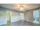 Light-filled bedroom featuring neutral paint, a ceiling fan, and closet and bathroom access at 16449 Cedar Crest Dr, Orlando, FL 32828