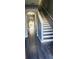 Inviting hallway with stylish gray flooring and a staircase, leading to the home's interior at 16449 Cedar Crest Dr, Orlando, FL 32828