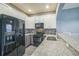 Well-equipped kitchen with granite countertops, sleek appliances, and updated lighting fixtures at 16449 Cedar Crest Dr, Orlando, FL 32828