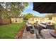 An outdoor patio with stone pavers, comfortable seating, a dining table and chairs, and green yard at 1649 W Waycross Cir, Deltona, FL 32725