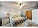 Comfortable bedroom with ceiling fan, wood-look closet doors, and neutral paint at 1649 W Waycross Cir, Deltona, FL 32725