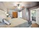 Comfortable bedroom with attached bathroom; neutral paint and wood-look closet doors at 1649 W Waycross Cir, Deltona, FL 32725