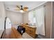 Bright bedroom with desk, comfortable chair, surfboard and wood-look dresser at 1649 W Waycross Cir, Deltona, FL 32725