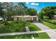 Charming single-story home boasts lush landscaping, a brick driveway, and inviting curb appeal at 1649 W Waycross Cir, Deltona, FL 32725