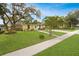Charming home with a well-manicured lawn, mature trees, and a welcoming front porch and sidewalk at 1649 W Waycross Cir, Deltona, FL 32725
