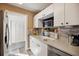 Bright kitchen features white cabinets, stainless steel appliances, and modern backsplash at 1649 W Waycross Cir, Deltona, FL 32725