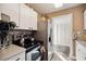 Bright kitchen features white cabinets, stainless steel appliances, and modern backsplash at 1649 W Waycross Cir, Deltona, FL 32725