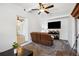 Spacious living room features a TV and a brown sofa with neutral carpeting at 1649 W Waycross Cir, Deltona, FL 32725