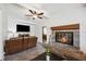 Bright living room featuring a fireplace and TV area with neutral carpeting at 1649 W Waycross Cir, Deltona, FL 32725