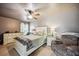 Comfortable bedroom with neutral tones and a queen-sized bed with updated furniture at 1649 W Waycross Cir, Deltona, FL 32725
