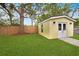 A charming shed with white trim, double doors, and a lush green lawn with trees at 1649 W Waycross Cir, Deltona, FL 32725