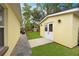 The side of a shed with white trim and double doors, a well-kept lawn, and trees at 1649 W Waycross Cir, Deltona, FL 32725