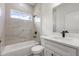 Well-lit bathroom with marble-style tiled shower and modern white vanity at 17477 Sw 41St Cir, Ocala, FL 34473