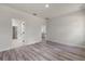 Bedroom with gray wood flooring and doorways leading to the kitchen at 17477 Sw 41St Cir, Ocala, FL 34473