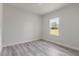 Relaxing bedroom with wood floors and a window with a lovely view at 17477 Sw 41St Cir, Ocala, FL 34473