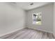 Well-lit bedroom with wood-look flooring and a view of the greenery outside at 17477 Sw 41St Cir, Ocala, FL 34473