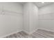 Empty walk-in closet with ample wire shelving and wood-look floors at 17477 Sw 41St Cir, Ocala, FL 34473