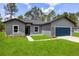 Charming single-Gathering home featuring a well-manicured lawn, a two car garage, and professional landscaping at 17477 Sw 41St Cir, Ocala, FL 34473