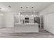 Modern kitchen features an island with pendant lighting and stainless steel appliances at 17477 Sw 41St Cir, Ocala, FL 34473