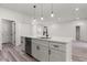Kitchen island with quartz countertops, stainless steel appliances, and modern lighting at 17477 Sw 41St Cir, Ocala, FL 34473