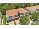Aerial view of townhomes, showcasing a tile roof, lush landscaping, and well-manicured driveways in a serene neighborhood at 1852 Garden Sage Dr, Oviedo, FL 32765
